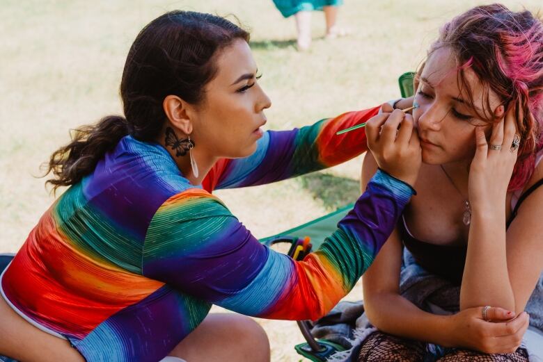 Harmony Scott, left, does makeup for Syd Tacknyk as part of the celebrations for National Indigenous Peoples day in Kenora, Ont., on June 21, 2022. 