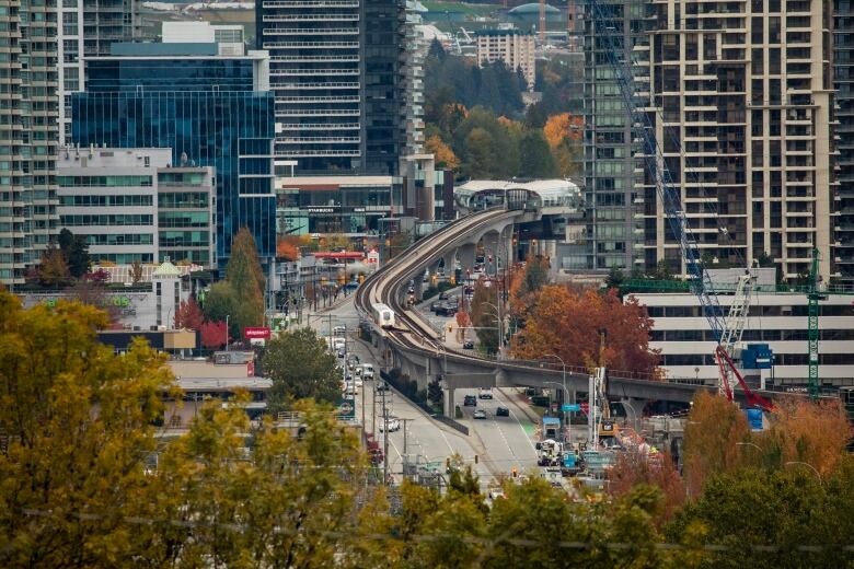 A SkyTrain is pictured travelling through the new towers of the Brentwood neighbourhood in Burnaby during fall.