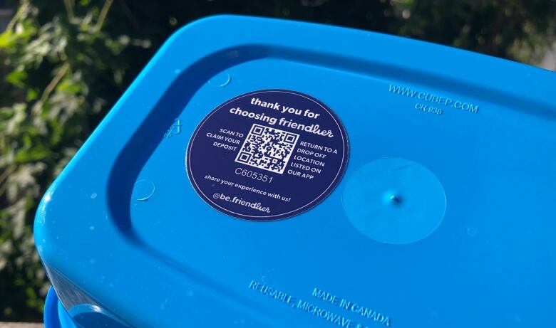 Bottom of blue reusable takeout container.