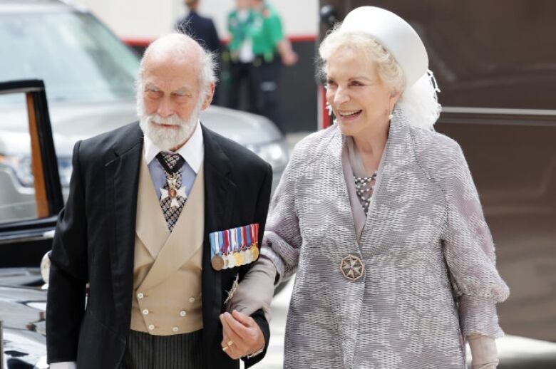 Two people walk after getting out of a car.