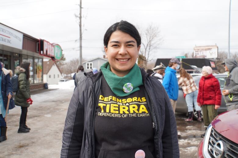 Malinali Castaneda-Romero is from Mexico and lives in Thunder Bay, Ont., she's shown at a recent climate rally. Her shirt reads 'defenders of the Earth' in English and Spanish. 