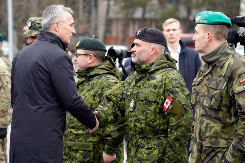 NATO Secretary General Jens Stoltenberg greets Canadian troops during a visit to Adazi Military base in Kadaga, Latvia on March 8, 2022.