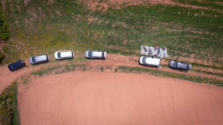 CFIA crews gather at their vehicles during a day of testing at a field in the Kensington, P.E.I. area. 