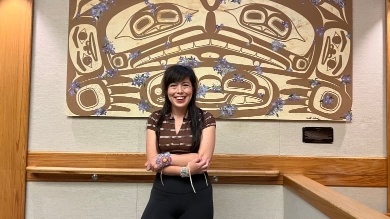 Violet Gatensby stands in front of her art inside the courtroom