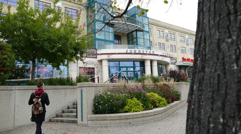 A person walks toward stairs leading up to the Johnson Terminal building.