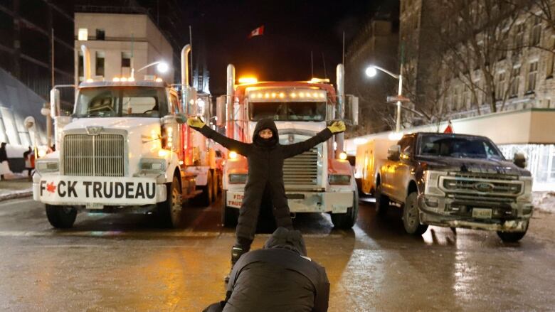 A protester and trucks.