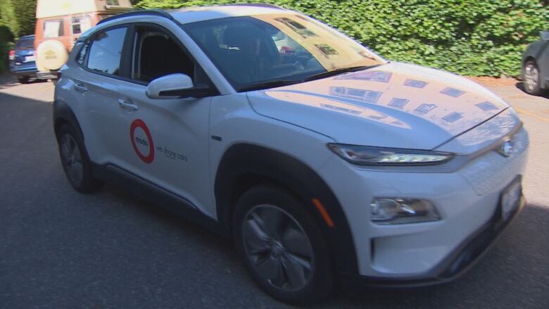 A modo-branded vehicle parked on the street.