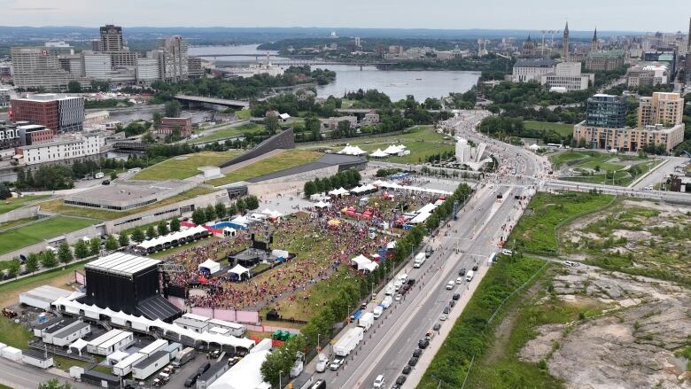 A crowd at a festival site is seen from the sky.