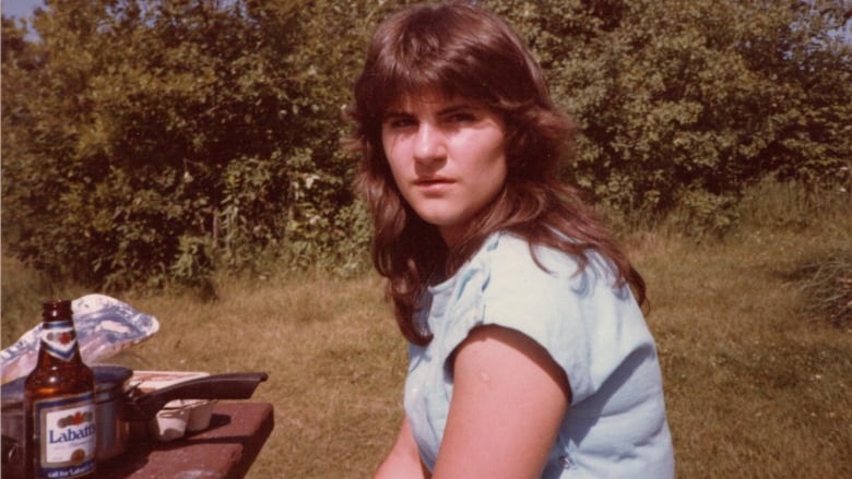 Teenage girl in the 1980s with a bottle of beer