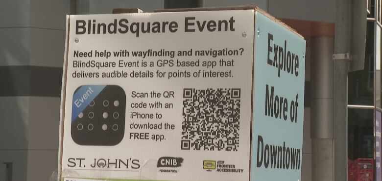 A poster advertises the BlindSquare app in Downtown St. John's. The poster contains a QR Code to allow users to download the iPhone app.