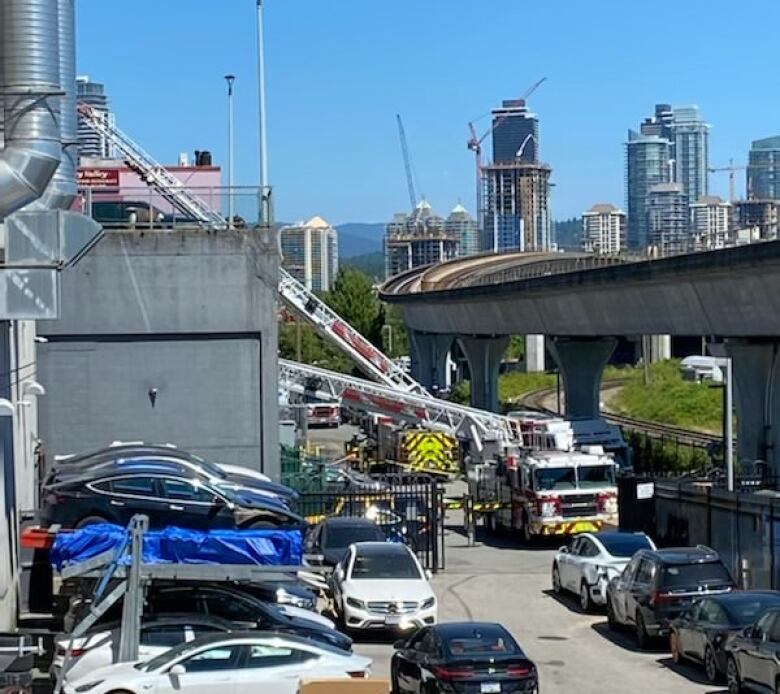 Vancouver firefighters respond after a rooftop parking deck collapsed onto the office space below on Thursday, July 14, 2022.