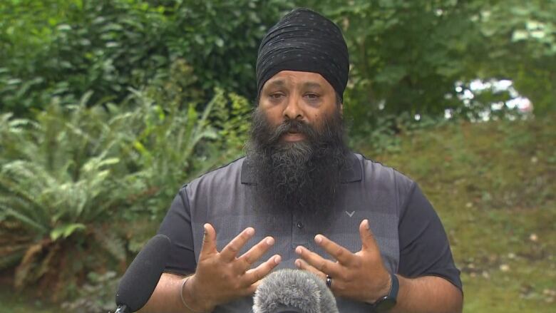 Jaspreet Singh Malik speaks to CBC News outside his home on Friday, a day after his father Ripudaman Malik was shot to death in the city.