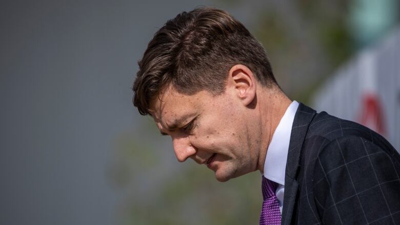 B.Cs Attorney General David Eby is pictured at the opening of Sunrise Soya Foods production facility in Delta, British Columbia on Tuesday, September 24, 2019.  Eby is shown in profile from the shoulders up, and he is looking downward.