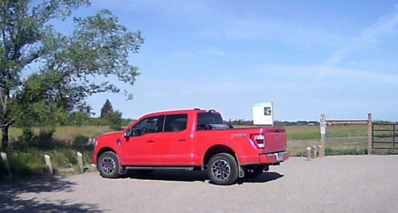 A red truck in a parking lot.