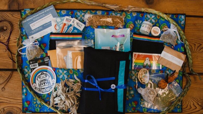 A kit lays flat on a table. It includes traditional medicines, including incense, as well as STD and HIV rapid test kits and other resources.