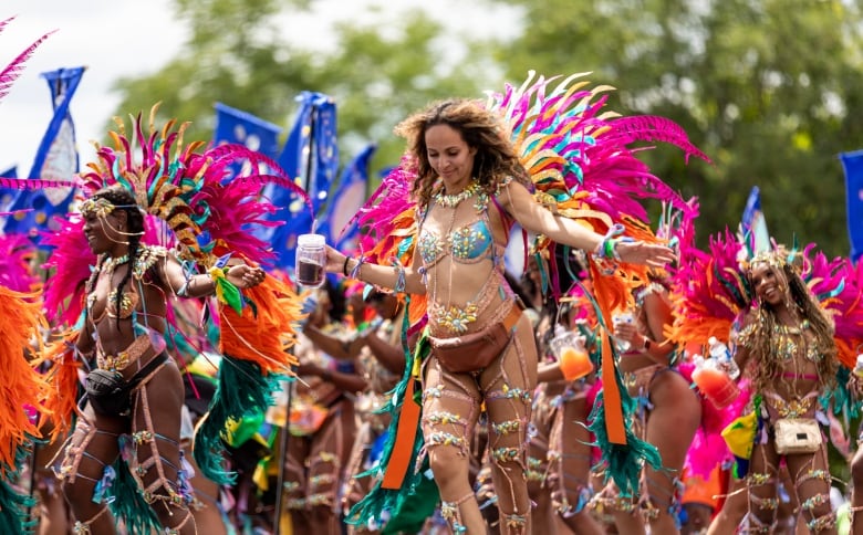 Scenes of dancers in costumes from the 55th Toronto Caribbean Carnival's Grand Parade at the Exhibition Place on July 30, 2022.