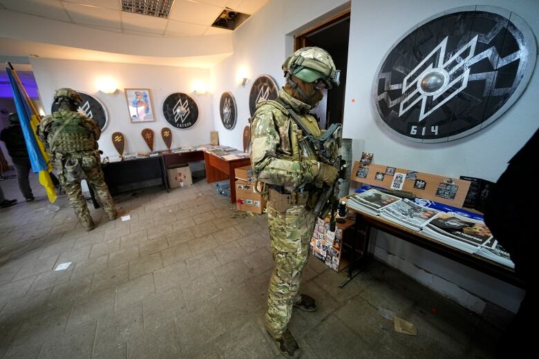 A soldier looks at pamphlets.