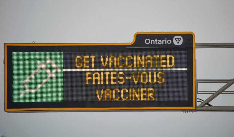 A sign over an Ontario highway that normally provides traffic information advises drivers to 