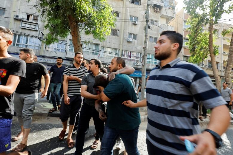 People assist an injured person after an explosion in Gaza City August 5, 2022. 