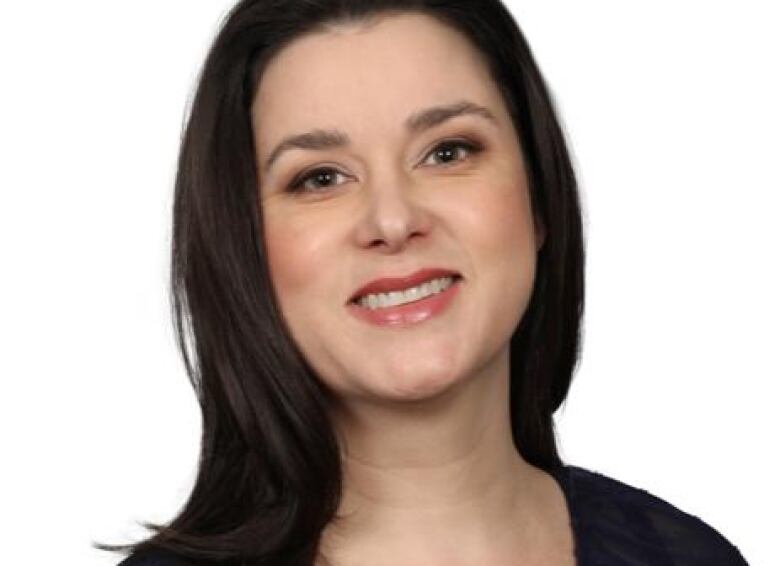 A headshot shows a woman with dark hair and eyes, smiling at the camera.