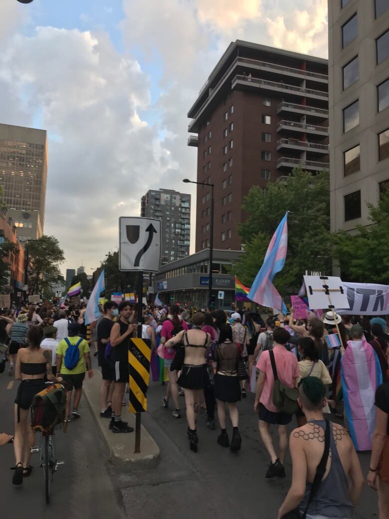 Crowds of people walk in a Montreal street.