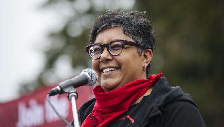 A woman standing in front of a microphone. 