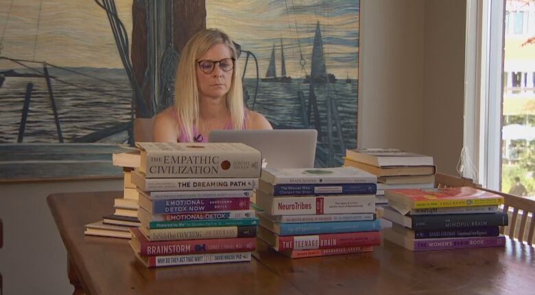 A woman works on a laptop.