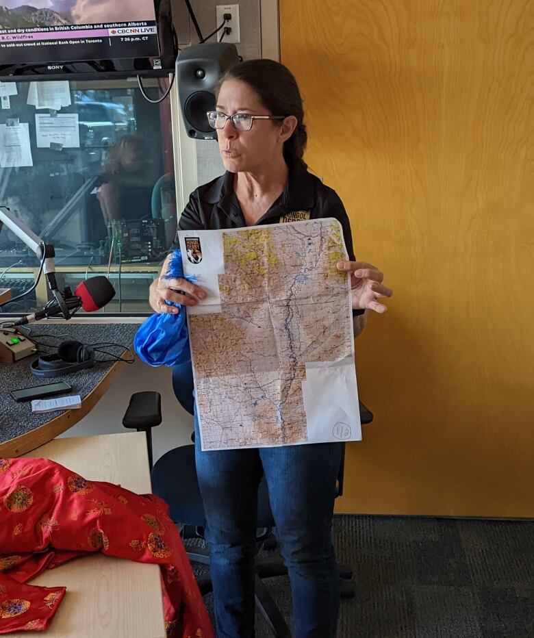 A woman holds a map.