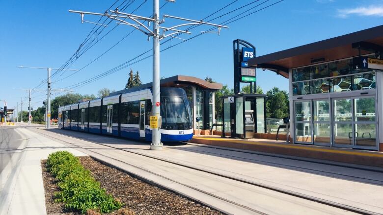 A streetcar-style LRT car at a stop.