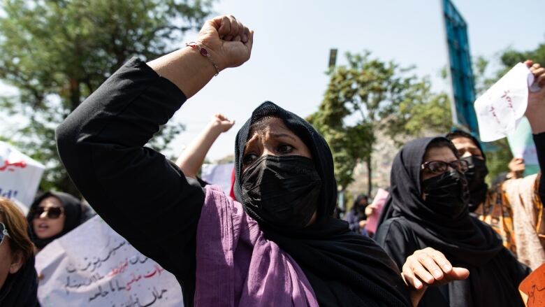 Taliban fighters fired into the air as they dispersed a rare rally by women who chanted, 