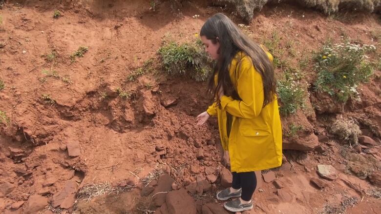 Erin Nelson showing freeable sand due to coastal erosion at QEP, Charlottetown