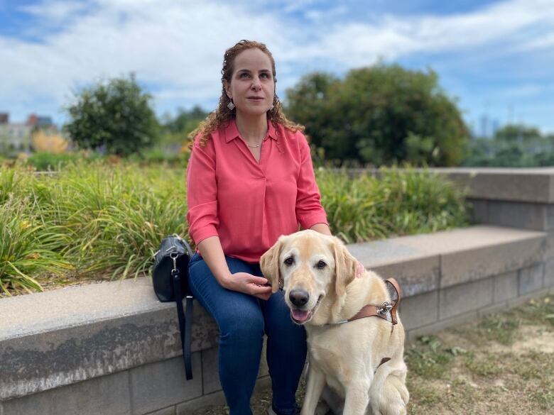 Daniella Levy-Pinto, pictured with her guide dog Angelo, is a spokesperson for Walk Toronto and wants people who drive SUVs and pickup trucks to understand the extent of the damage these vehicles can cause.