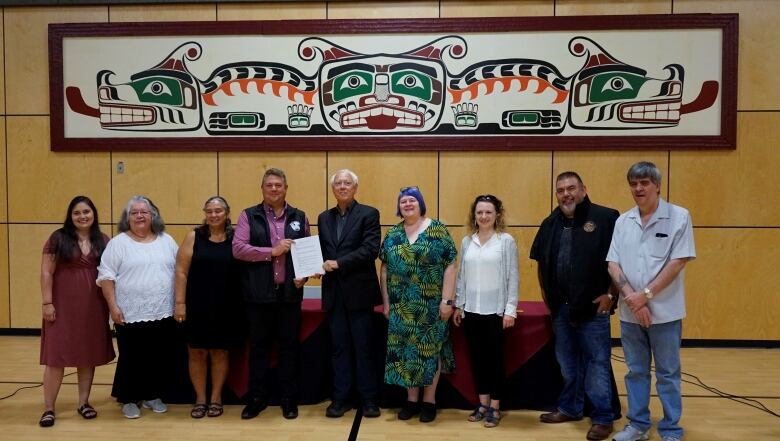 Members of the Wei Wai Kum First Nation and the Province of B.C., pose with the signed Incremental Treaty Agreement that will return land back to the First Nation.