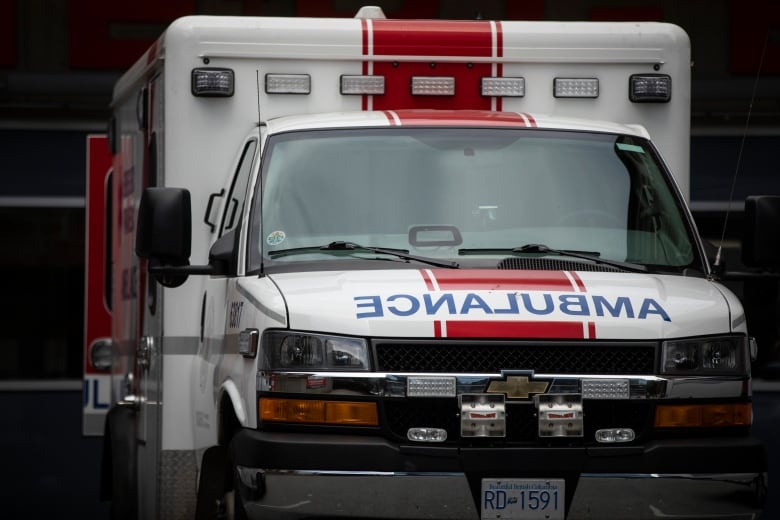 An ambulance with the word 'AMBULANCE' written in reverse font.