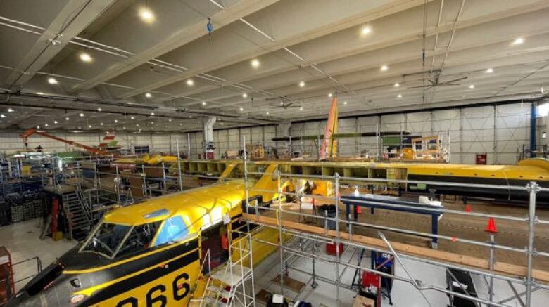 A water-bomber being built in a factory.