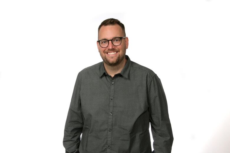 Man stands in front of white background