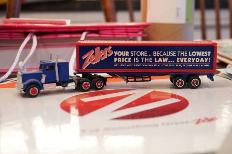 A toy truck with the slogan 'your store... because the lowest price is the law... everyday!'