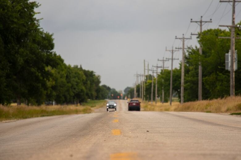 A car drives on a country road.