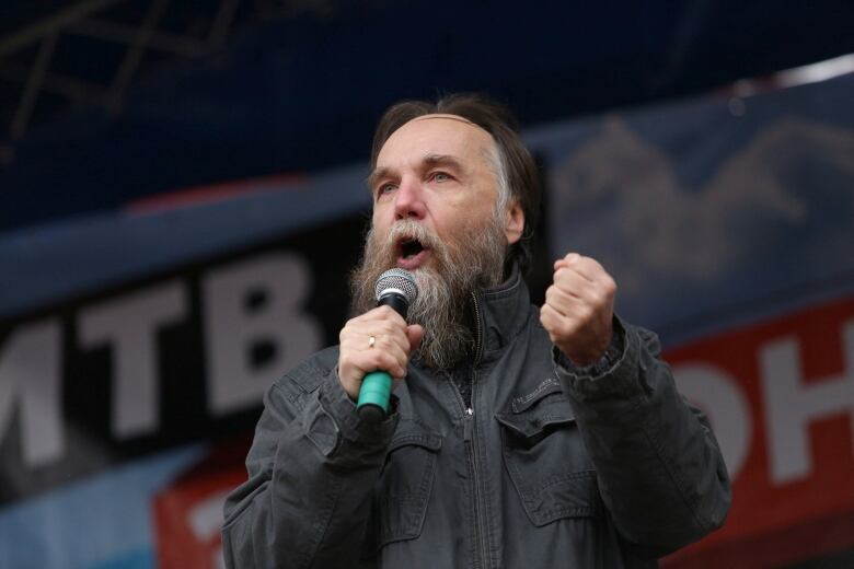 A man speaks into a microphone.