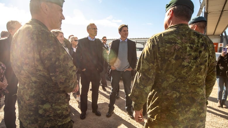 NATO Secretary General Jens Stoltenberg and Prime Minister Justin Trudeau speak with military members about the North Warning System Site in Cambridge Bay, Nunavut on Thursday, August 25, 2022.