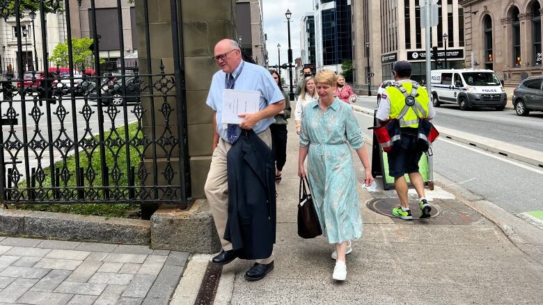 A man and woman enter the gates at Province House in downtown Halifax.