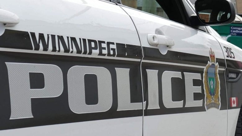 Winnipeg police black and white car parked on street.