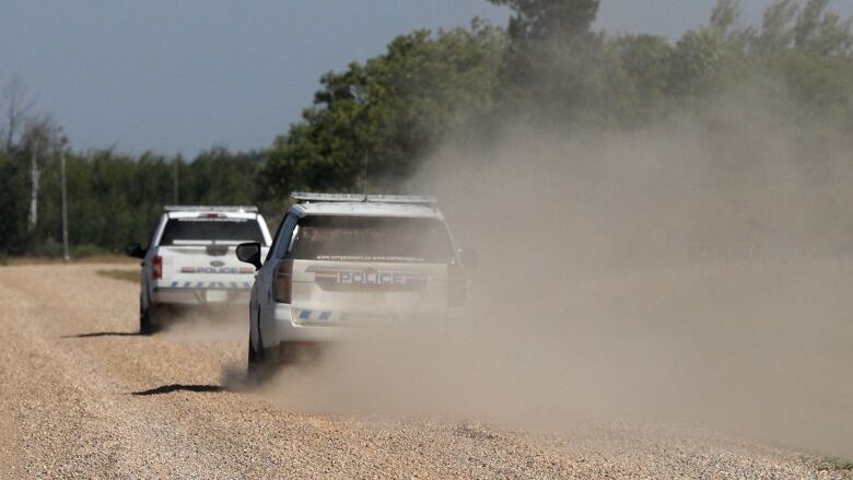 Royal Canadian Mounted Police vehicles patrol James Smith Cree Nation after a possible sighting of the remaining suspect in the stabbings that occurred on the reserve and the nearby town of Weldon, Sask.