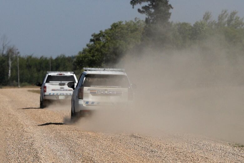 Royal Canadian Mounted Police vehicles patrol James Smith Cree Nation after a possible sighting of the remaining suspect in the stabbings that occurred on the reserve and the nearby town of Weldon, Sask.