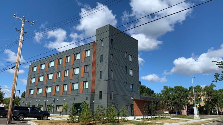 A grey and orange apartment building.