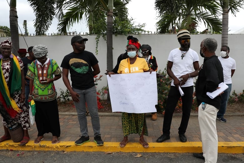 Protesters hold signs