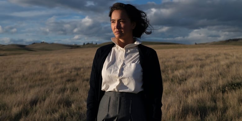 Woman standing in field.