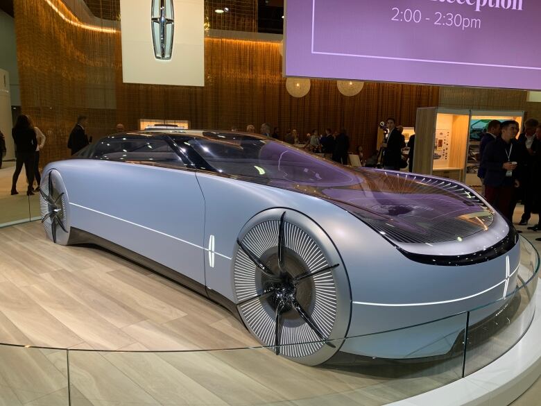 A light blue electric vehicle on display