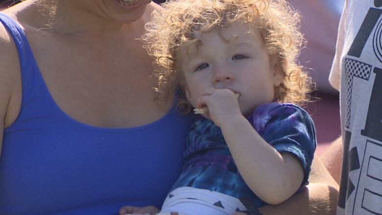 Toddler eating a graham cracker. 