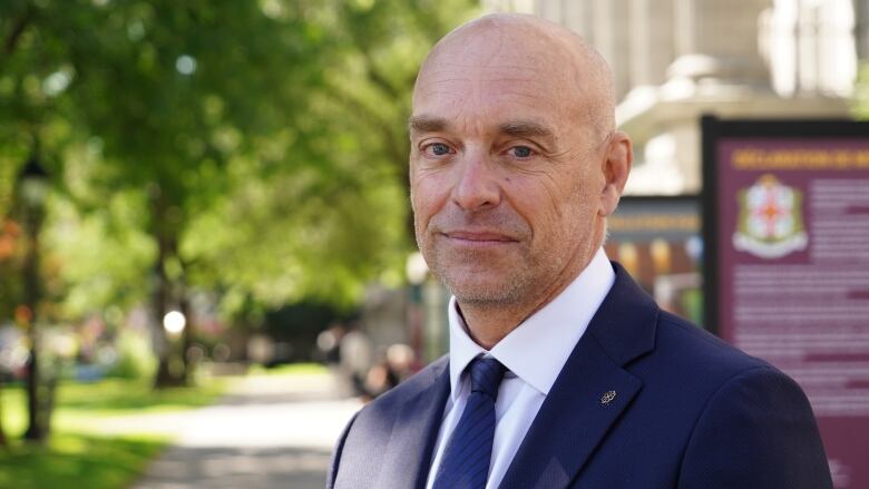 Portrait of a man in a blue suit.